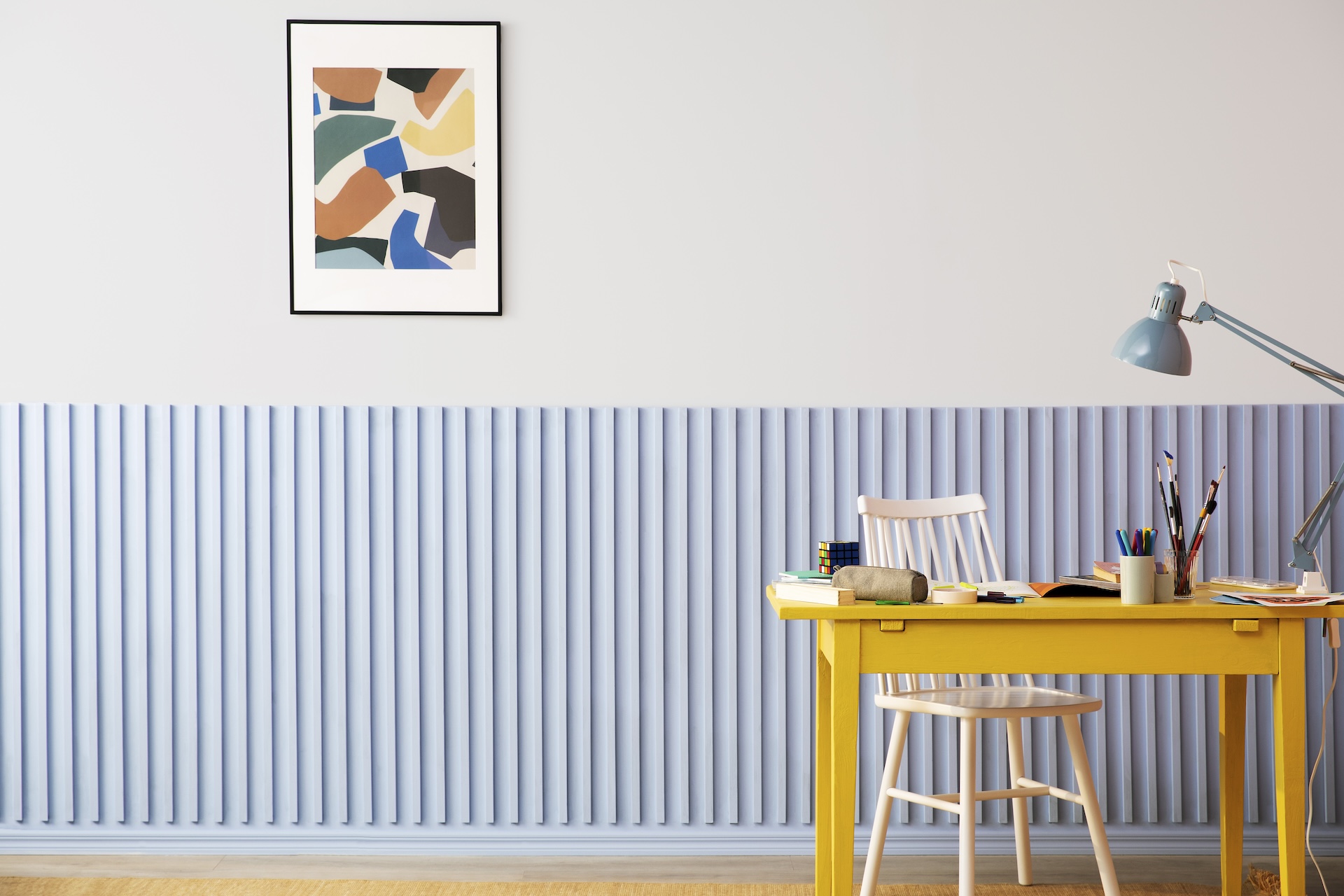 Blue painted kids room with a desk