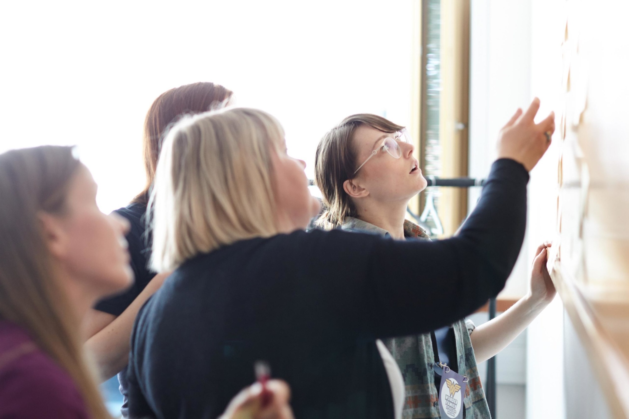 People co-working on a whiteboard