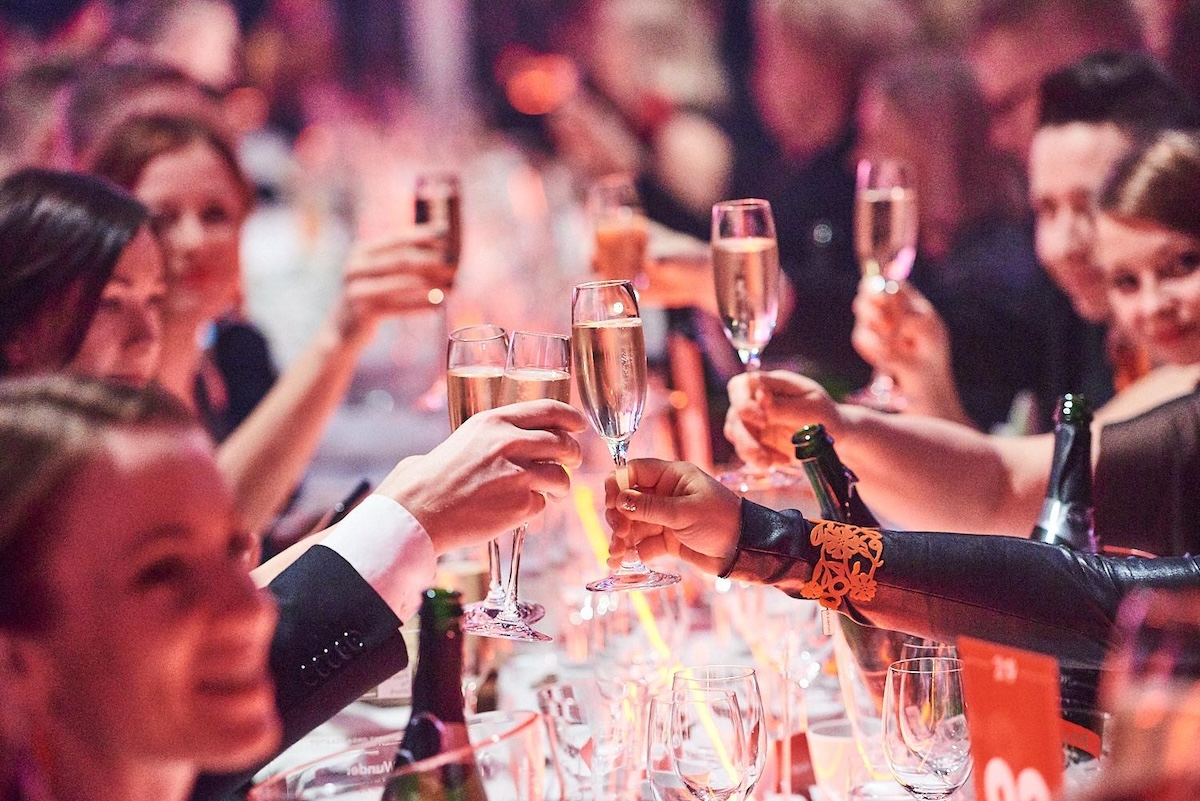Happy people around table in the Great Place to work -gala