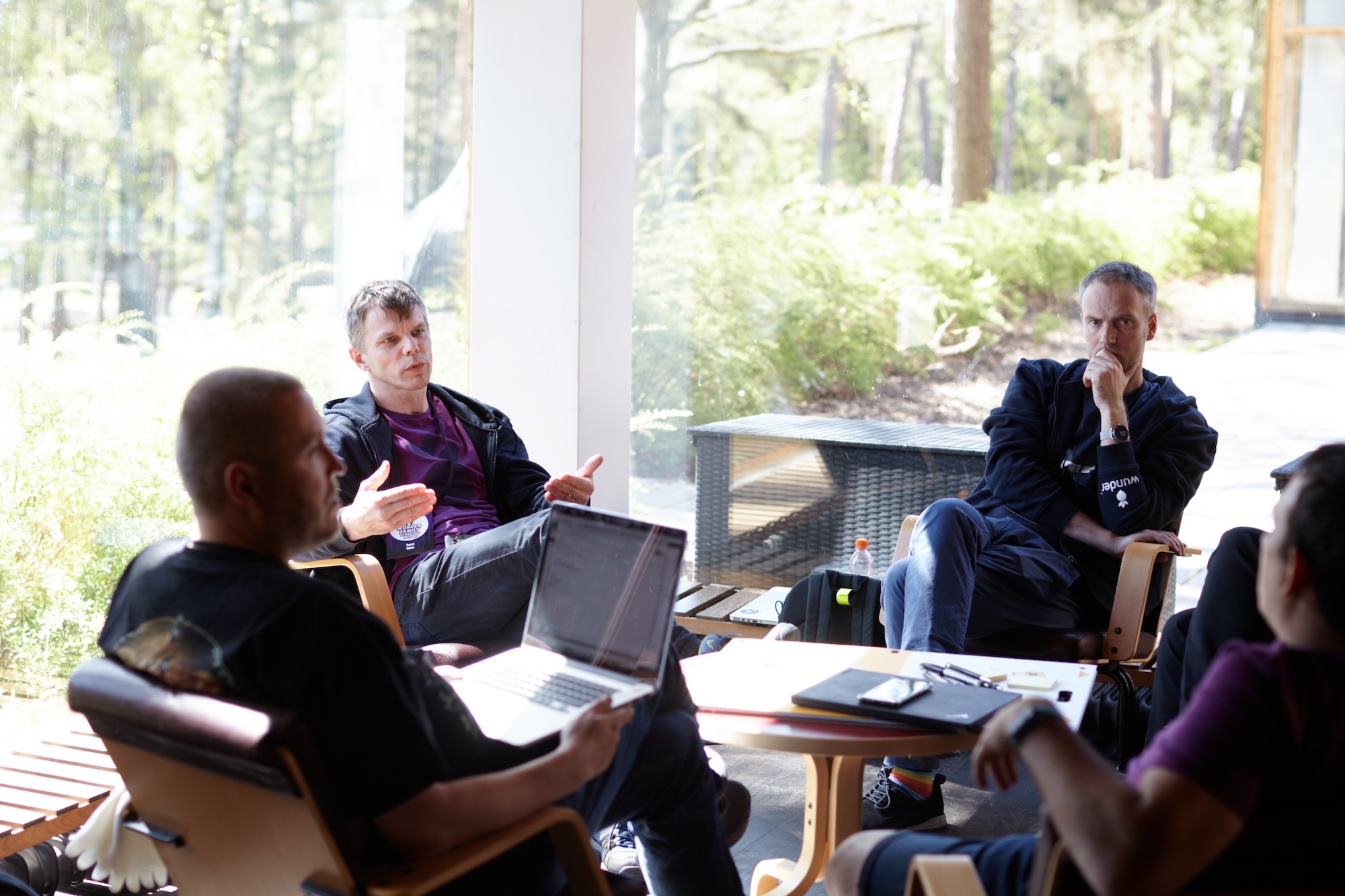 group of people sitting in a circle and discussing