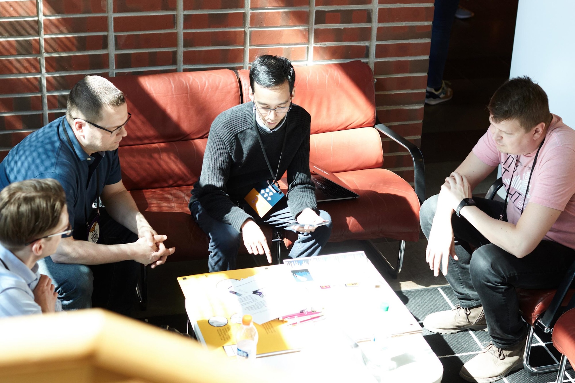 People sitting around table having a meeting.