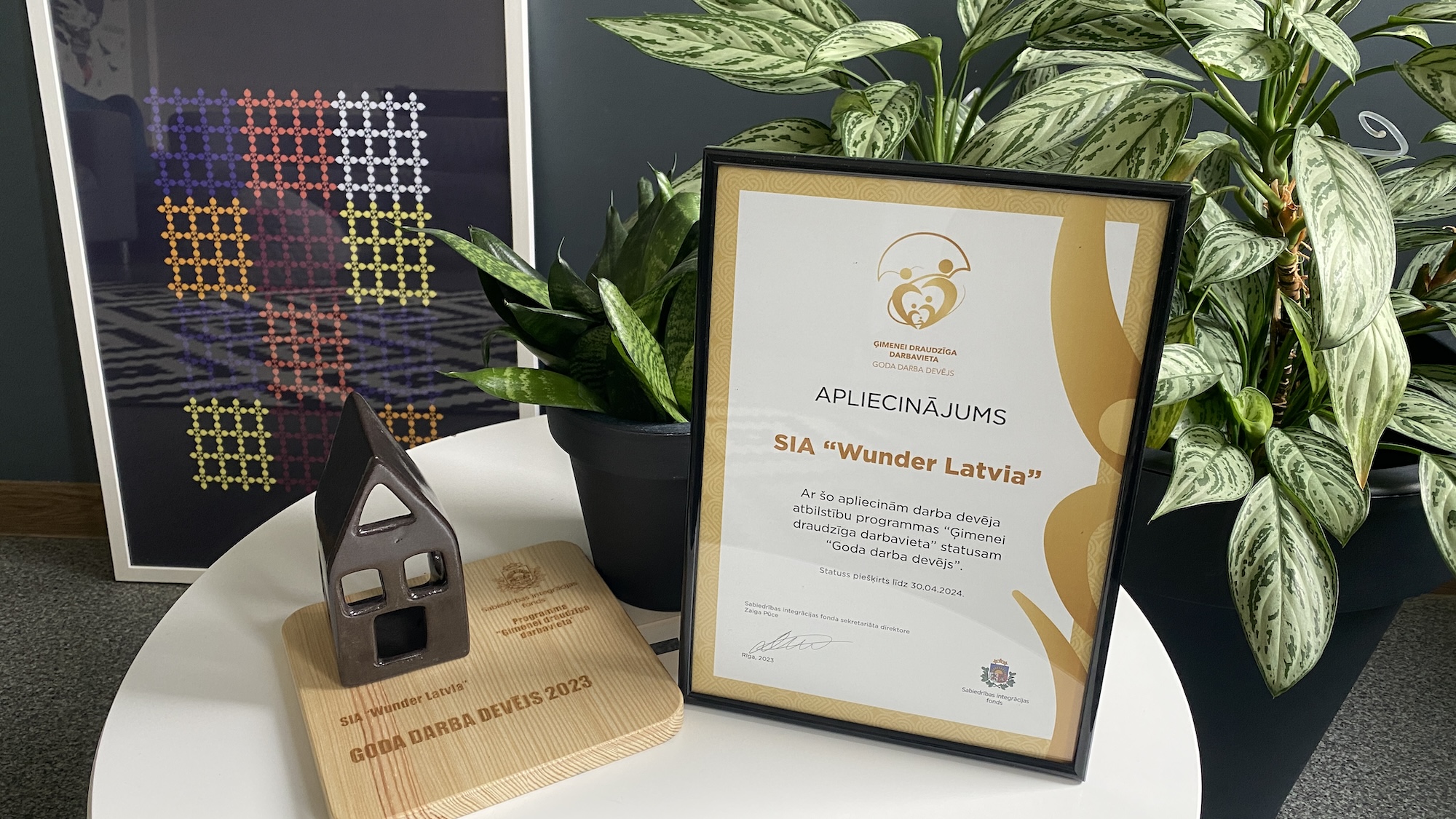 Honorable employer award and a small potted plant on a round table