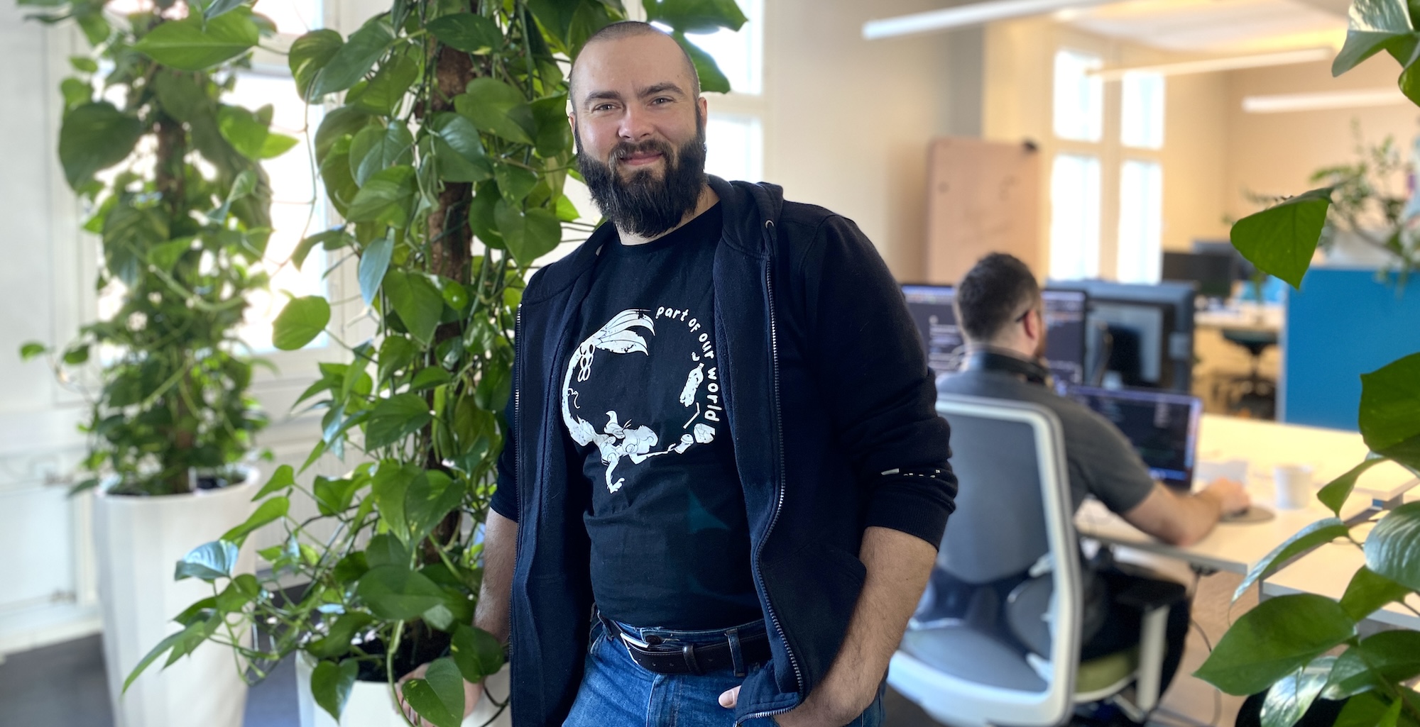 Janne Koponen smiling at Mearra Helsinki office with green plants in the background