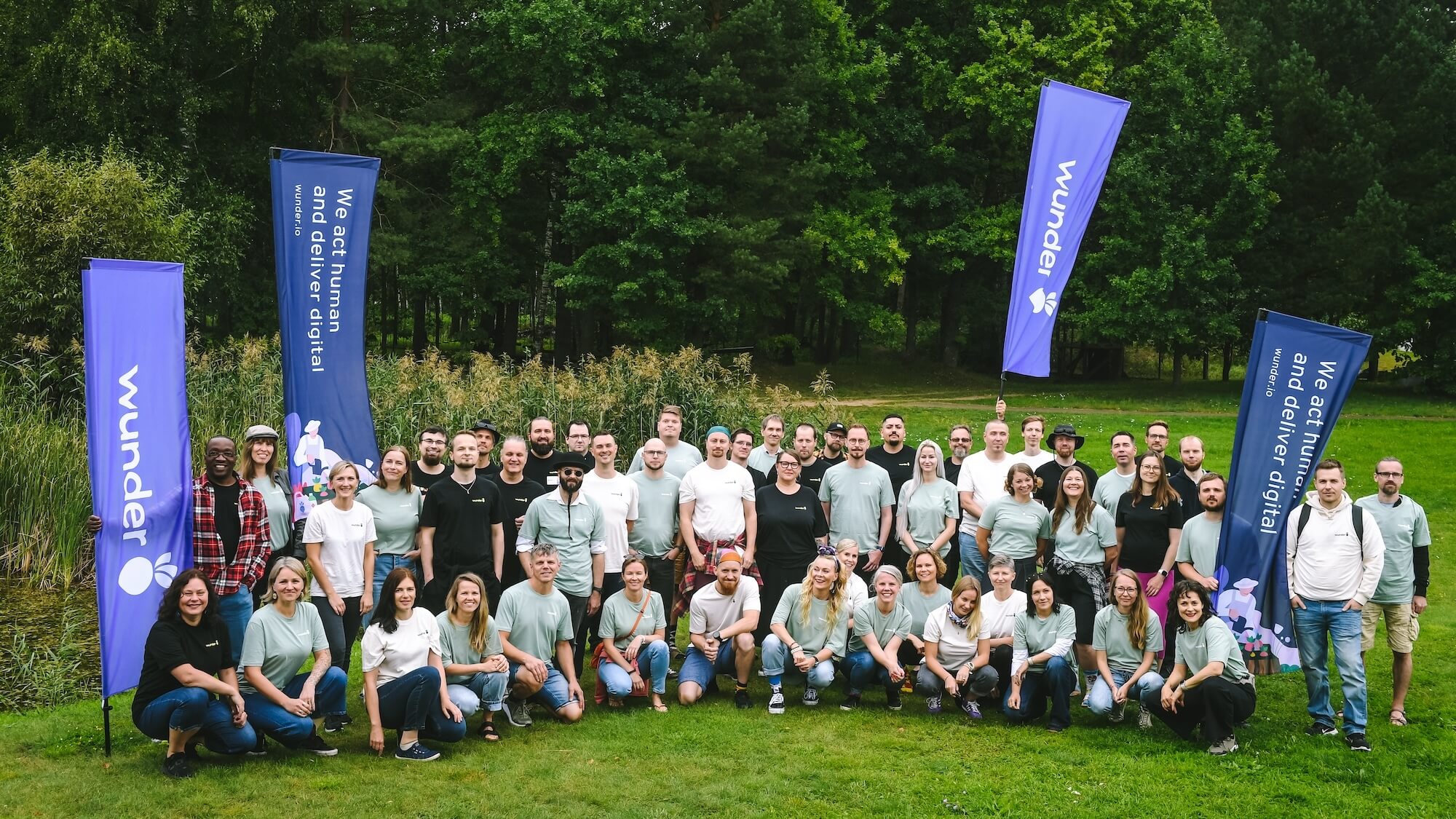 Group picture of Mearra people holding four flags
