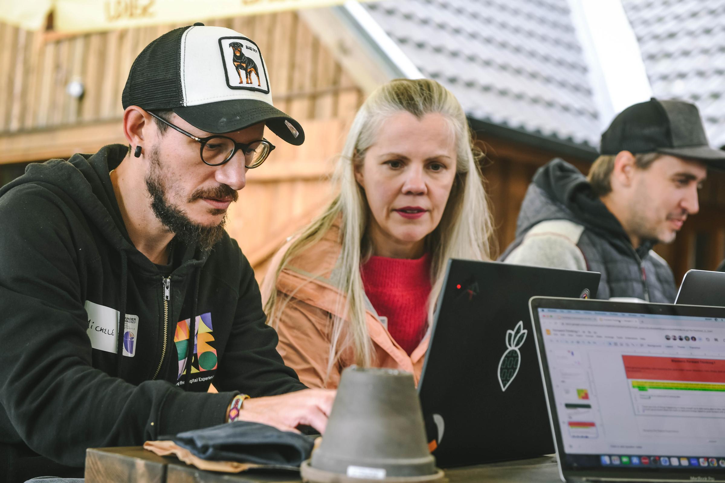 People working together around a table with their laptops